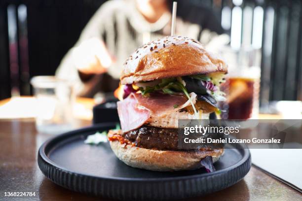 appetizing hamburger on plate in fast food cafe - flora gonzalez imagens e fotografias de stock