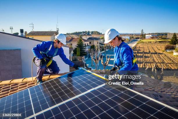 measuring solar panels installation on a roof - high up stock pictures, royalty-free photos & images