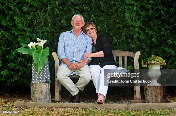 loving couple - garden bench stock pictures, royalty-free photos & images