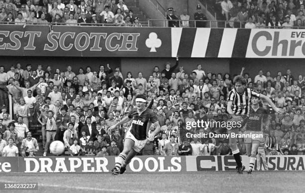 Newcastle striker Chris Waddle shoots at goal watched by Villa defender Steve Foster and the Newcastle fans in the East Stand benches, Waddle's shot...