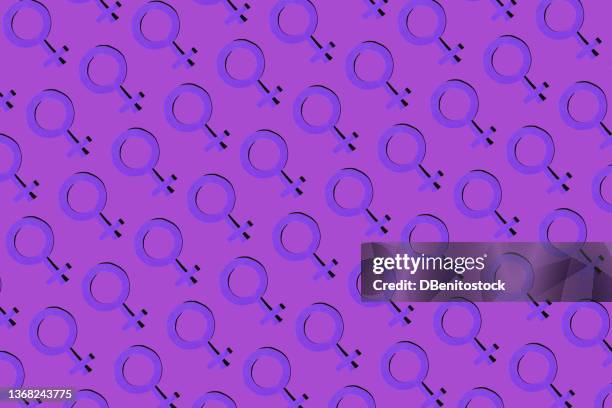 woman symbol pattern in purple color on purple background. concept of women's day, empowerment, equality, inequality, activism and protest. - colors against violence in madrid stockfoto's en -beelden