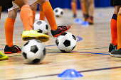 Indoor Soccer Class for Kids at School Sports Hall. Children Kicking Soccer Balls on Wooden Futsal Floor. Sport Football Practice For Preschool Boys