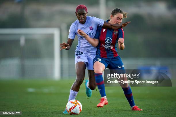 Nuria Mendoza of Levante UD women competes for the ball with Asisat Oshoala of FC Barcelona women during the Primera Iberdrola league match between...