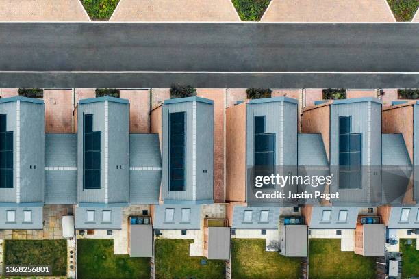 drone view of a new housing development with solar panels - sustainable living - cleantech stock pictures, royalty-free photos & images