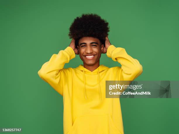 african american man with afro hair standing over isolated  background - man and his hoodie imagens e fotografias de stock