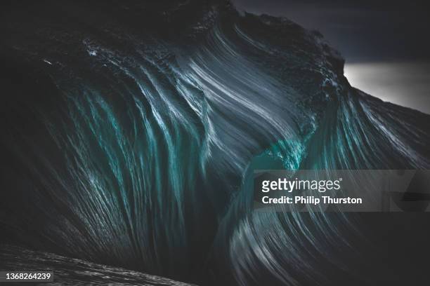 full frame teal blue textures of dark ocean wave - seascape stockfoto's en -beelden