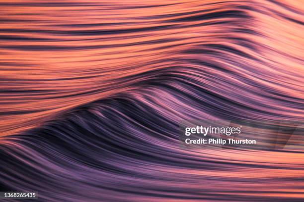 slow shutter of texture of oceans surface in pink light - patterns in nature stock pictures, royalty-free photos & images