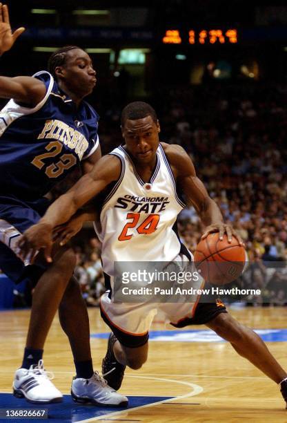 Oklahoma State's Tony Allen drives past Pittsburgh's Christ Taft during the first half of play at the Continental Airlines Arena in East Rutherford,...