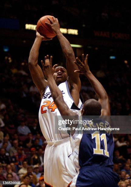 Oklahoma State's Tony Allen gets a shot off over Pittsburgh's Caral Krauser during the first half of play at the Continental Airlines Arena in East...