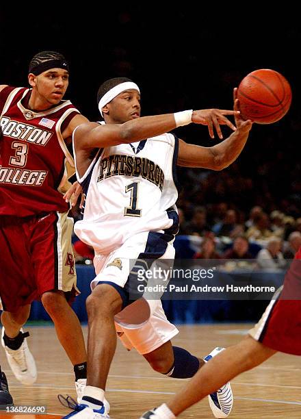 Pittsburgh's Julius Page dishes off a pass as Boston College's Jared Dudley defends during first half action at Madison Square Garden in New York...