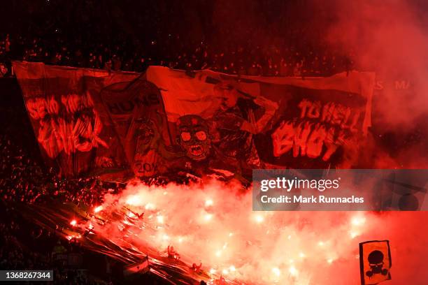 Celtic fans light flares and unfurl a banner as they show their support before the start of the Cinch Scottish Premiership match between Celtic FC...