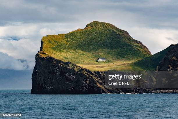 world’s loneliest house - the lodge on the elliðaey in iceland. - iceland mountains stock pictures, royalty-free photos & images