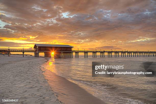 sunrise through the pier. - golfküstenstaaten stock-fotos und bilder