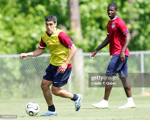 Eddie Johnson watches Claudio Reyna push the ball forward In the final training session at the camp at SAS Park, in Cary, North Carolina on May 21...