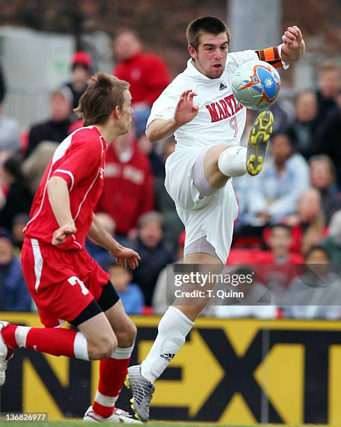 Jason Garey of Maryland reaches high for the ball in front of Patrik Engstrom of St. Johns in a game where Maryland beat St. John's 3-1 in a third...