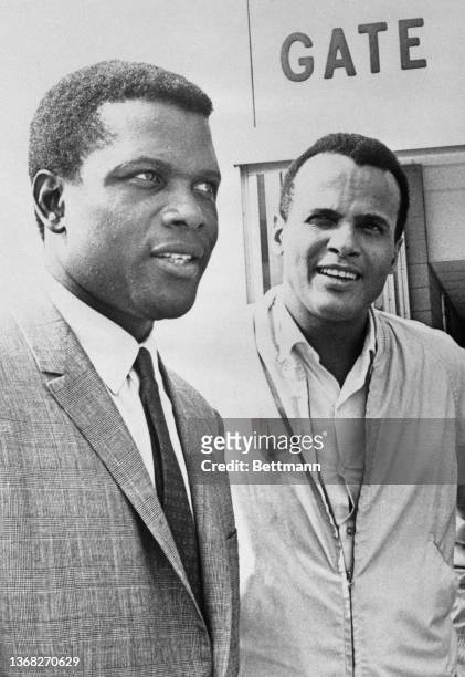 Academy Award winning actor Sidney Poitier and singer Harry Belafonte talk to reporters after presenting a $70.00 check to civil rights leaders to...