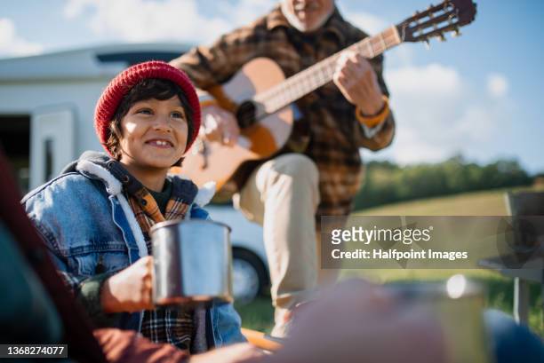 little multiracial boy camping with father and grandfather in nature. - family caravan stockfoto's en -beelden