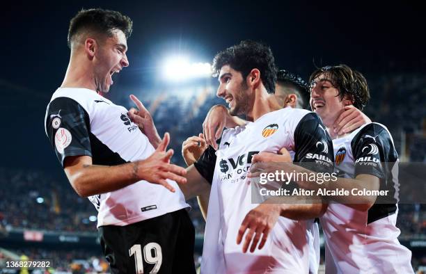 Goncalo Guedes of Valencia CF celebrates with his teammate Bryan Gil and Hugo Duro of Valencia CF after scoring the opening goal during during the...