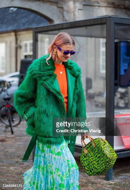 Marianne Theodorsen seen wearing Balenciaga sunglasses, faux fur jacket in green, Prada skirt, Louis Vuitton bag outside Stine Goya during Copenhagen...