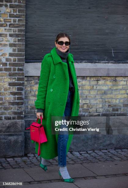 Darja Barannik seen wearing green coat, red Hermes bag, turtleneck, heels with socks outside Day Birger et Mikkelsen during Copenhagen Fashion Week...