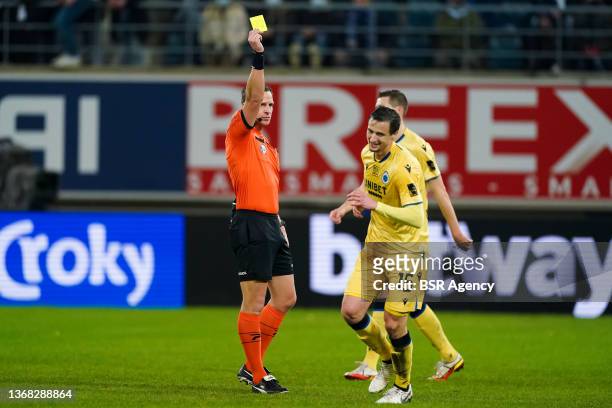 Referee Nathan Verboomen shows a yellow card to Matej Mitrovic of Club Brugge during the Croky Cup Semi Final 1st Leg match between KAA Gent and Club...