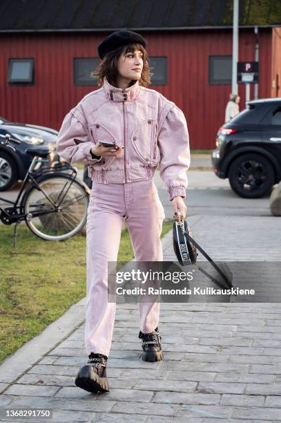 Lea Naumann wearing full pink denim outfit and black beret outside Soulland in Copenhagen fashion week Autumn/Winter 2022 on February 02, 2022 in...