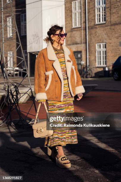 Renia Jaz wearing knitted dress, beige bag, brown jacket and beige Gucci slide sandals outside Day Birger et Mikkelsen in Copenhagen fashion week...