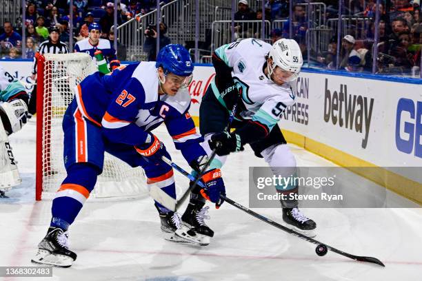 Anders Lee of the New York Islanders and Jeremy Lauzon of the Seattle Kraken battle for the puck during the second period at UBS Arena on February...