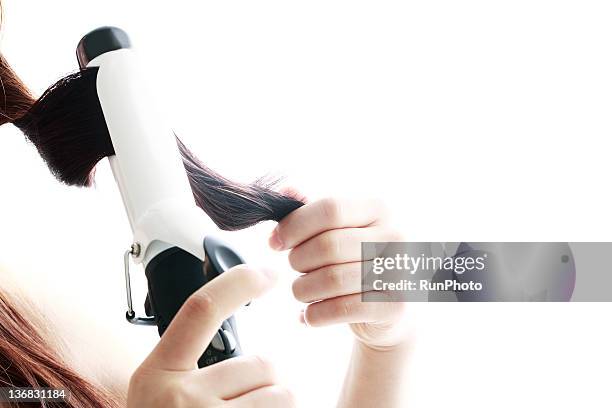 young woman using curling iron,close-up - hair curlers stock pictures, royalty-free photos & images