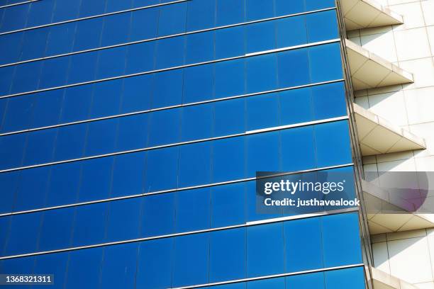 blue colored glassy fensterfront of modern office building in bangkok chatuchak - fensterfront bildbanksfoton och bilder