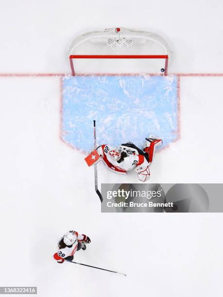 Goalkeeper Andrea Braendli and Alina Marti of Team Switzerland look on as the puck hits off the post during the Women's Ice Hockey Preliminary Round...