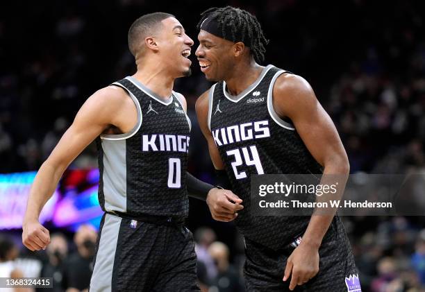 Buddy Hield and Tyrese Haliburton of the Sacramento Kings reacts after Hill made a thee-point shot against the Brooklyn Nets during the second half...