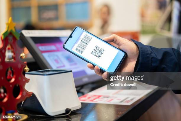 payment with mobile phone in modern supermarket - counter intelligence stock pictures, royalty-free photos & images