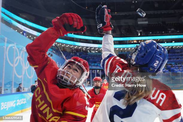 Huier Huang of Team China and Aneta Tejralova of Team Czech Republic reach for a puck in the air in the third period during the Women's Ice Hockey...