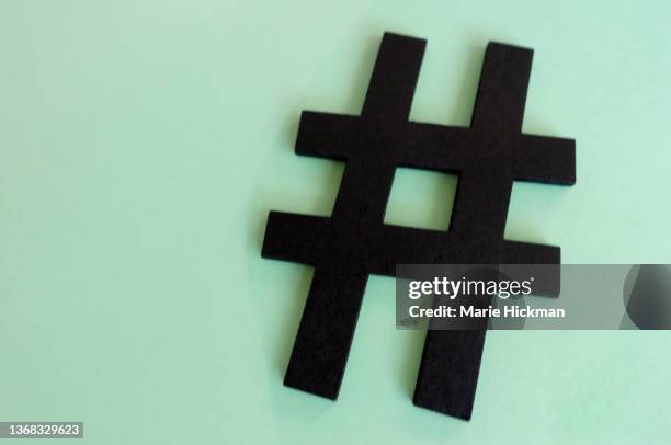 black colored hashtag on a green mint background - hashtag stock-fotos und bilder