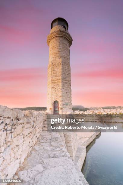 old lighthouse under the pink sky at sunset, rethymno - crete stock pictures, royalty-free photos & images