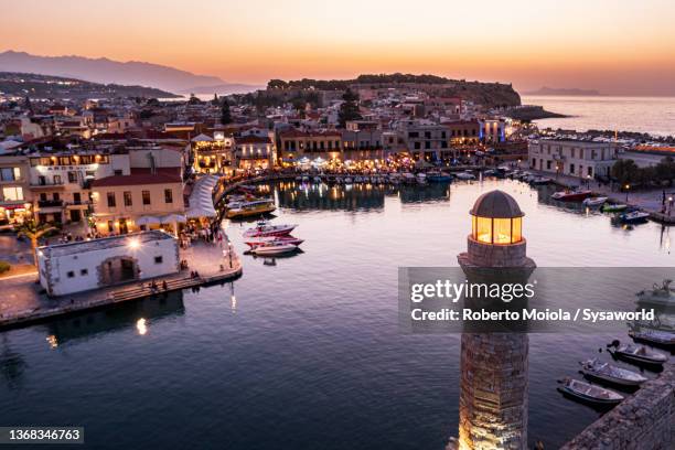 old lighthouse and harbor at dawn, rethymno, crete - crete rethymnon stock pictures, royalty-free photos & images