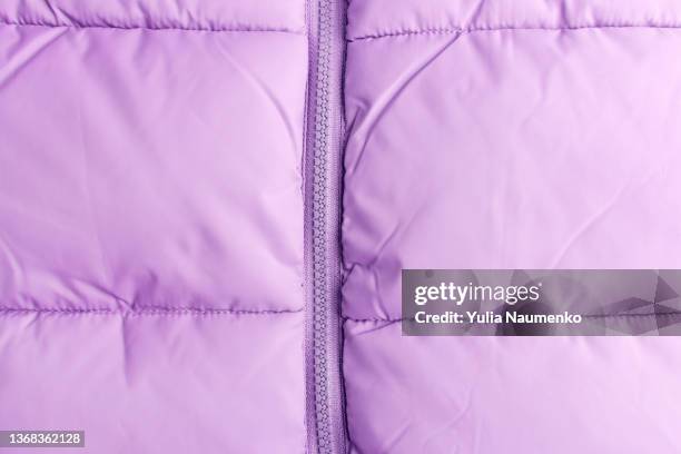 zipper on a quilted jacket. close-up of puffer jacket texture with zipper - padded jacket stockfoto's en -beelden