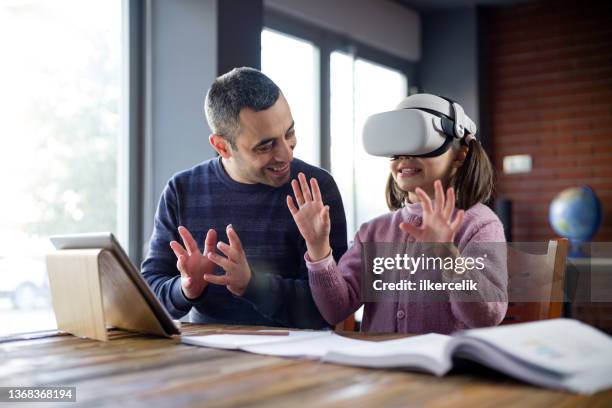 father assisting her daughter doing homework via metaverse - 3d daughter stock pictures, royalty-free photos & images