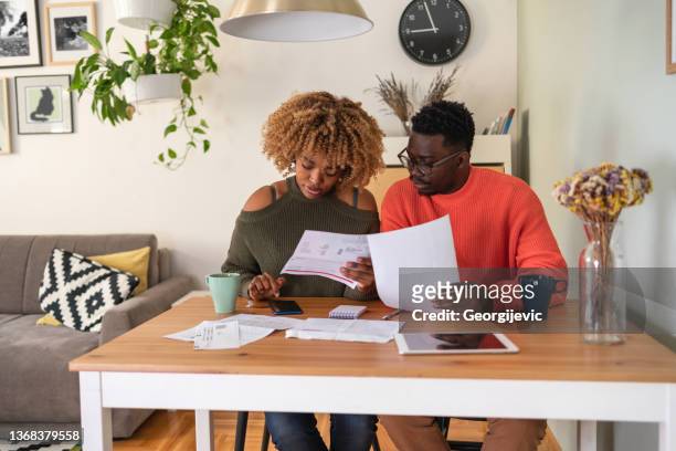 the couple planning their home budget - budget bildbanksfoton och bilder