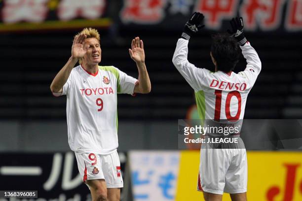 Frode Johnsen of Nagoya Grampus Eight celebrates scoring a goal with his team mate Toshiya Fujita during the J.League J1 match between Oita Trinita...