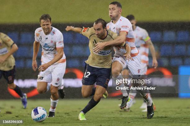 Angus Thurgate of the Jets is contested by Scott Neville of the Roar during the round 13 A-League men's match between Newcastle Jets and Brisbane...