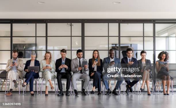 business people using digital devices - people in a row stock pictures, royalty-free photos & images