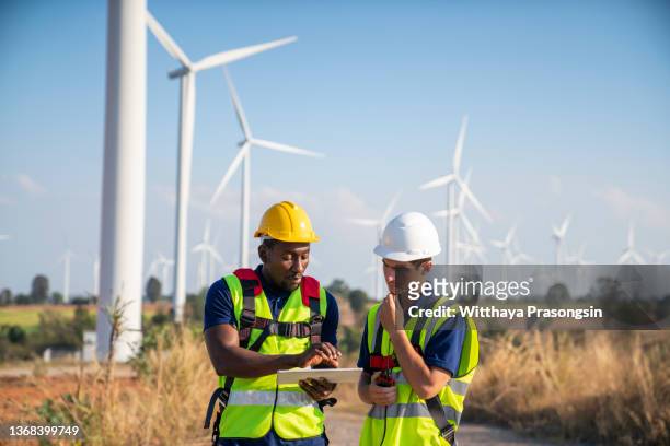 engineers of wind turbine - safety harness stock pictures, royalty-free photos & images