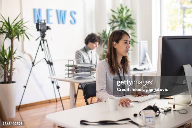 multiracial female and male coworkers working on new publication at the editorial office - editorial office stock pictures, royalty-free photos & images