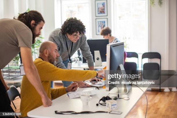 coworkers working on new publication at the editorial office - editorial office stock pictures, royalty-free photos & images