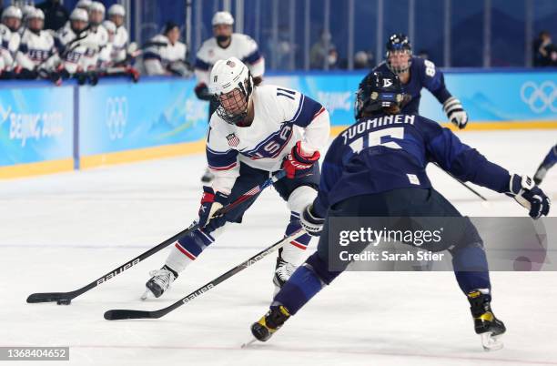 Abby Roque of Team United States takes on Minnamari Tuominen of Team Finland during the Women's Ice Hockey Preliminary Round Group A match between...