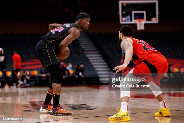 Jimmy Butler of the Miami Heat dribbles by Fred VanVleet of the Toronto Raptors during the second half of their NBA game at Scotiabank Arena on...