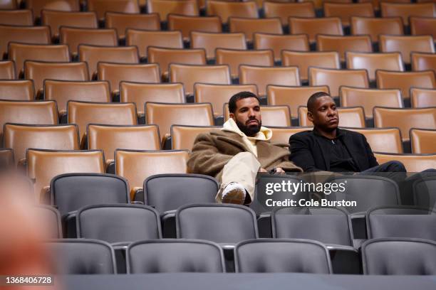 Toronto rapper Drake speaks with Toronto Raptors president Masai Ujiri during the first half of NBA game between the Toronto Raptors and the Miami...