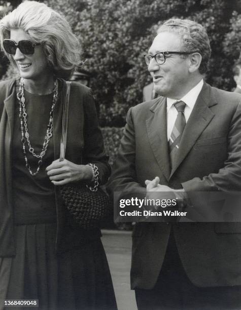 View of married couple, philanthropist Nancy Kissinger and former US Secretary of State Henry Kissinger, as they smile during an unspecified outdoor...